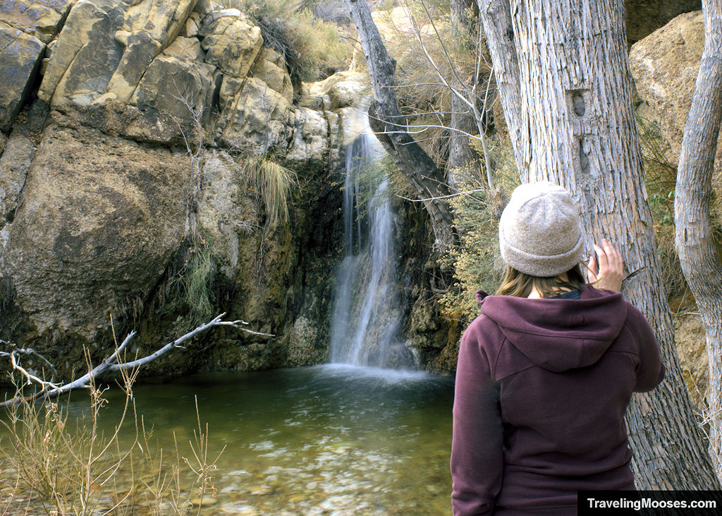Women looking wistfully towards hidden waterfall
